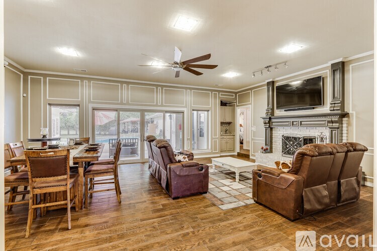 A living room with a fireplace and a television.