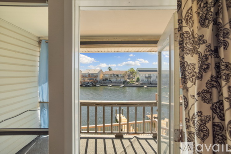 A balcony with a view of a waterway and buildings.
