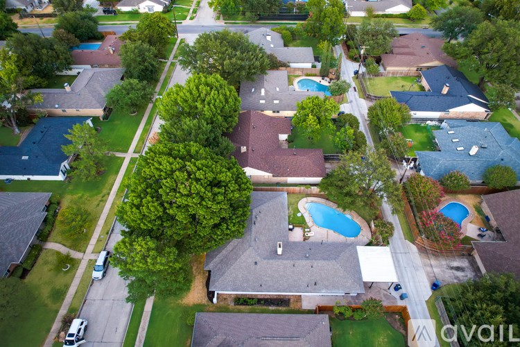 A bird's eye view of a neighborhood with houses and swimming pools.