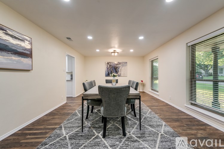 A dining room with a table set for four.