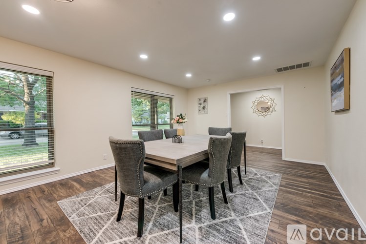 A dining room with a table and chairs.