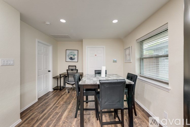 A dining room with a table and chairs.
