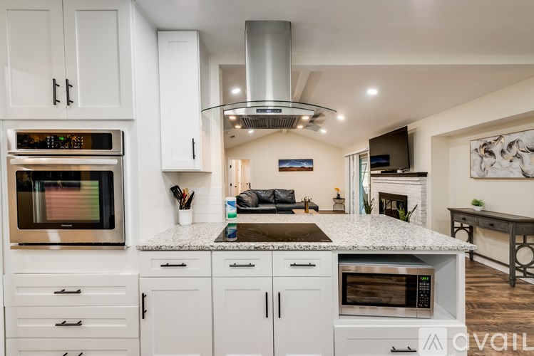 A modern kitchen with white cabinets and a central island.