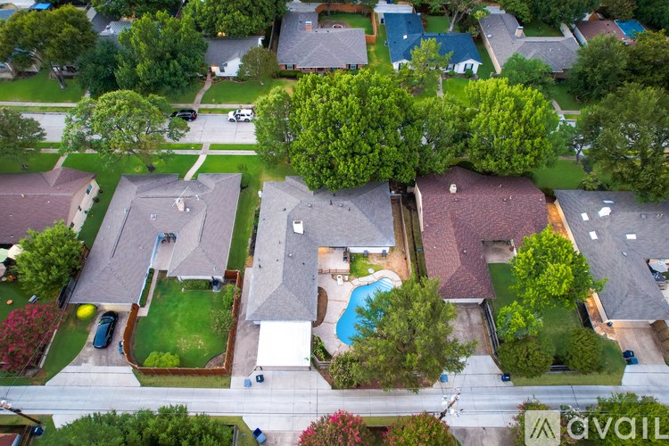 A bird's eye view of a neighborhood with houses and cars.