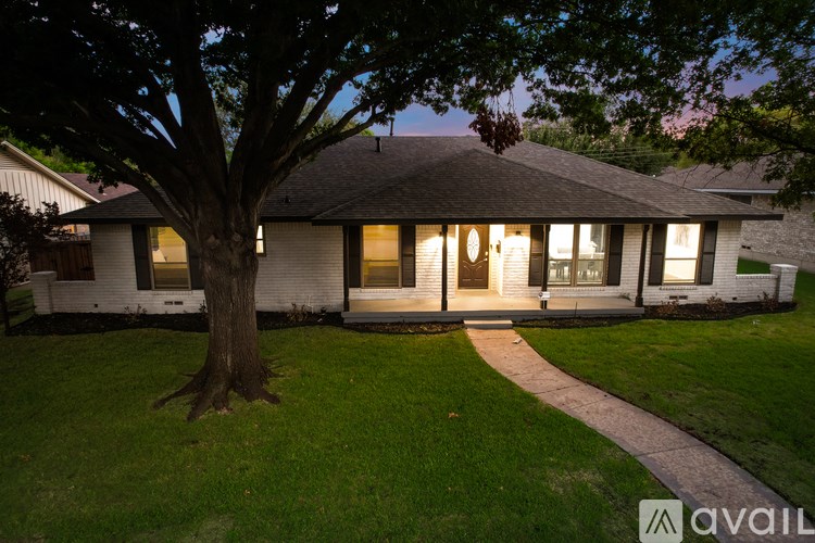 A house with a tree in front of it.