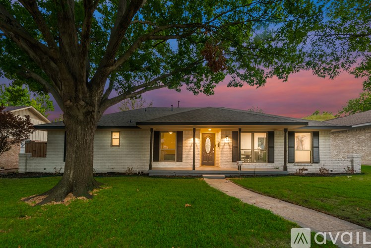 A house with a tree in front of it is available for sale.