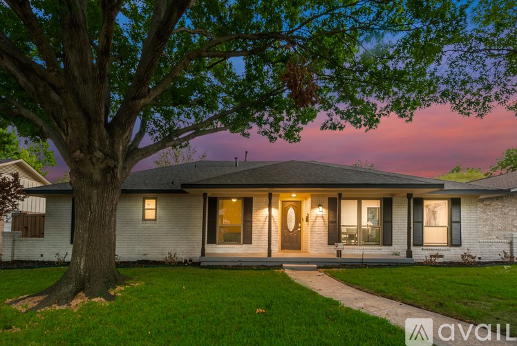 A house with a tree in front of it is available for sale.
