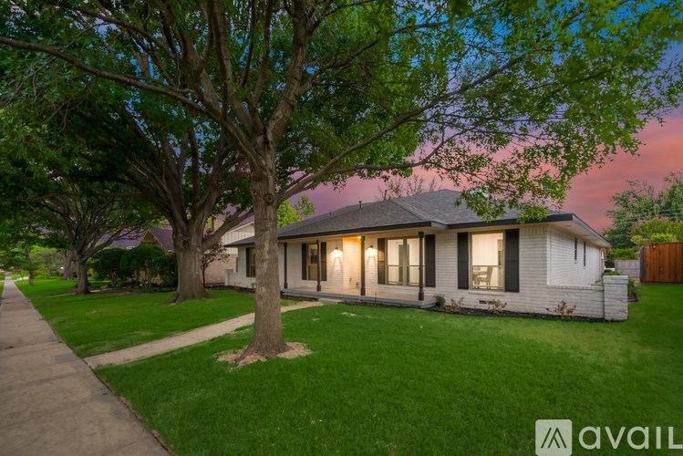 A house with a tree in front of it.