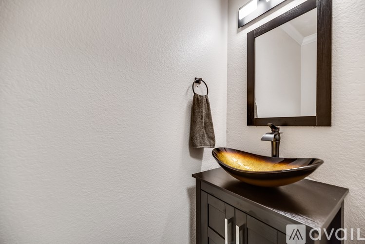 A bathroom with a wooden sink and a mirror above it.