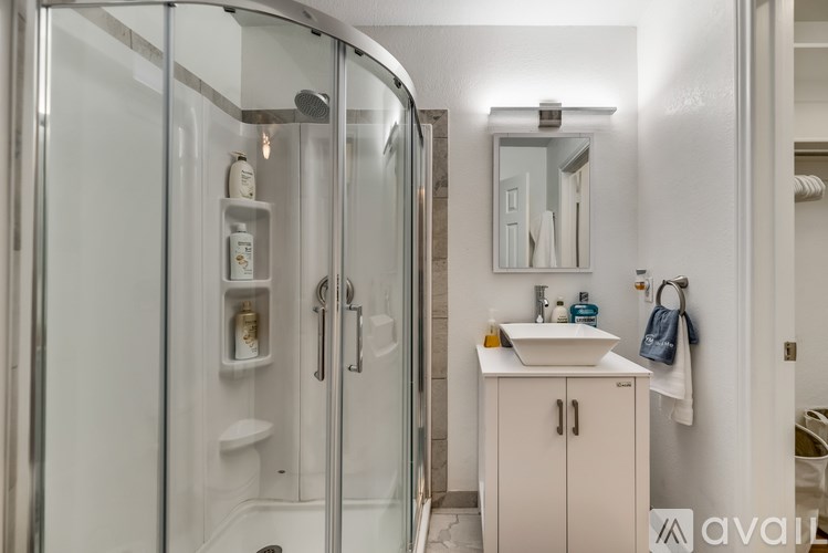 A bathroom with a white sink and a white cabinet.