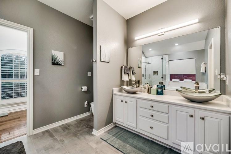 A bathroom with two sinks and a large mirror.