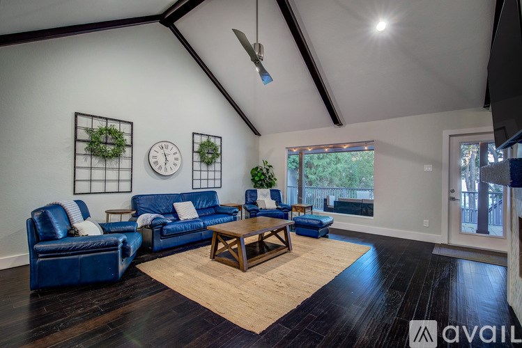 A living room with blue couches and a wooden coffee table.