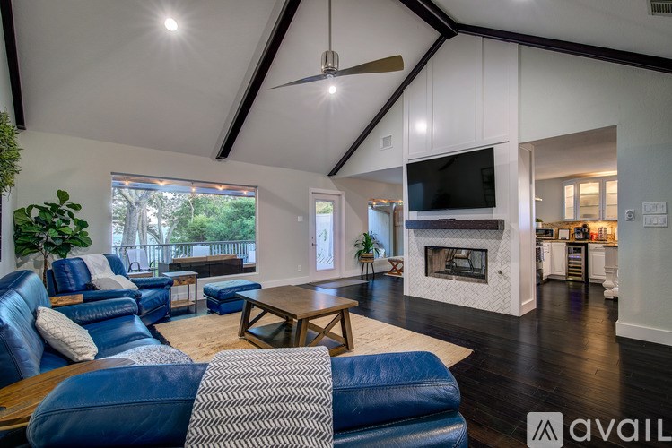 A living room with a blue couch and a television.