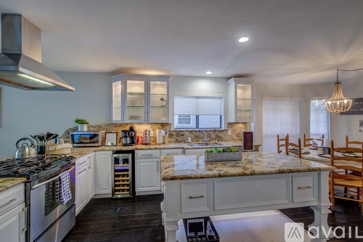 A kitchen with a stove top oven and a refrigerator.