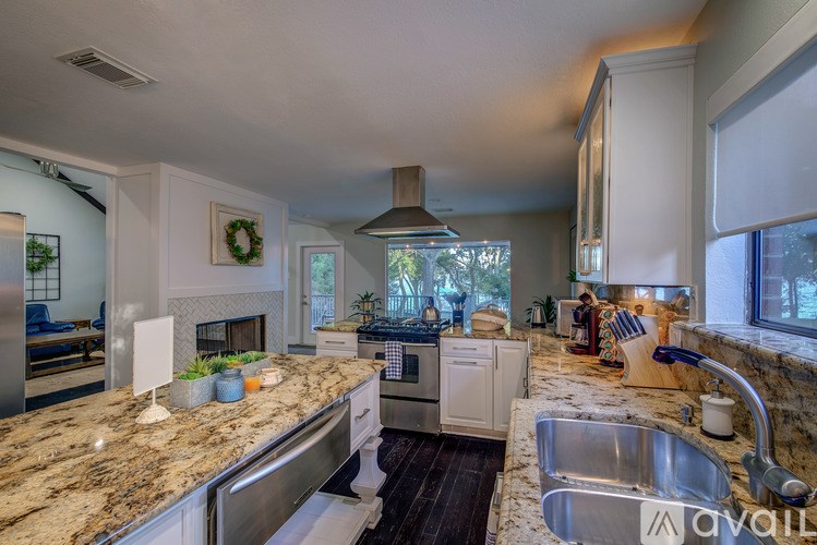 A kitchen with granite countertops and stainless steel appliances.