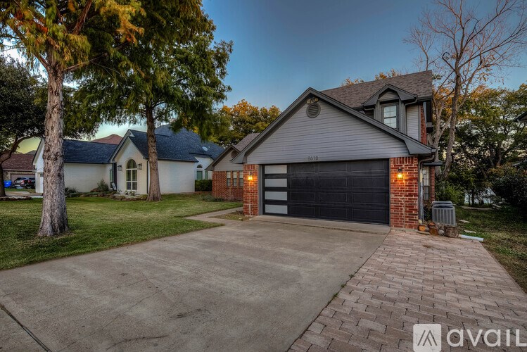 A house with a driveway and garage is available for sale.