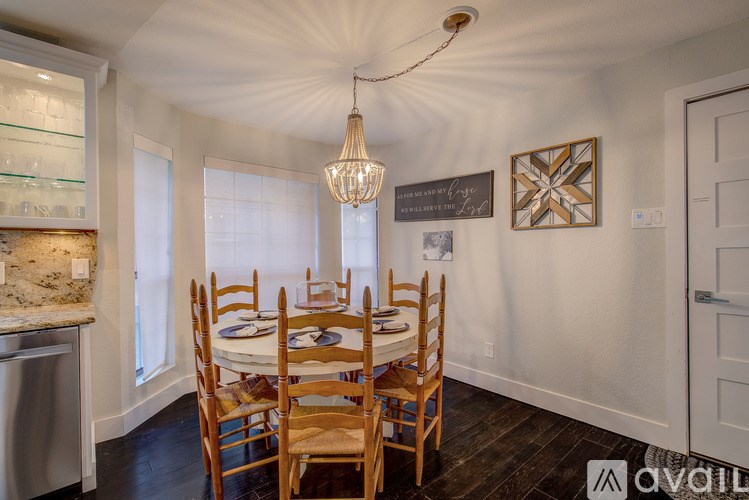 A dining room with a table set for six people.