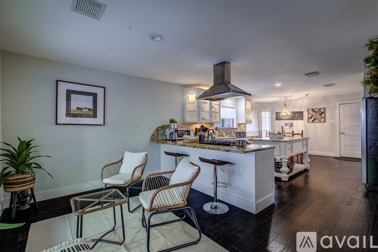 A modern kitchen with a bar area and seating.