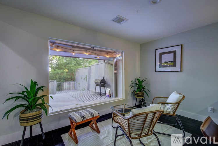 A balcony with a table and chairs overlooks a deck.