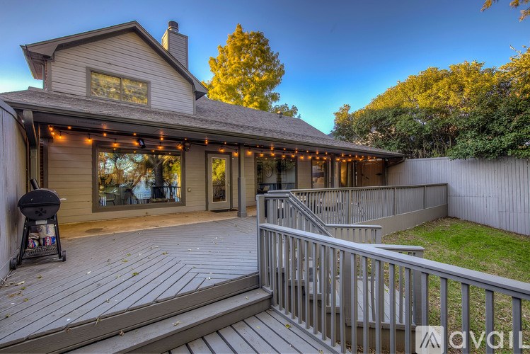 A house with a deck and a grill on it.