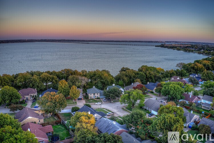 A bird's eye view of a residential neighborhood with houses and trees.
