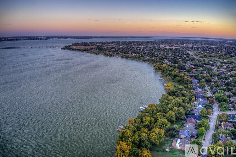 A beautiful aerial view of a residential area along a waterfront at sunset.