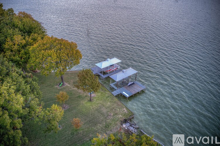 A house is situated on a small island in the middle of a lake.