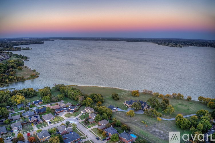 A bird's eye view of a residential area with houses and a body of water.
