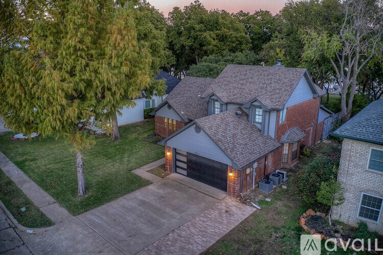 A house with a driveway and garage is available for sale.