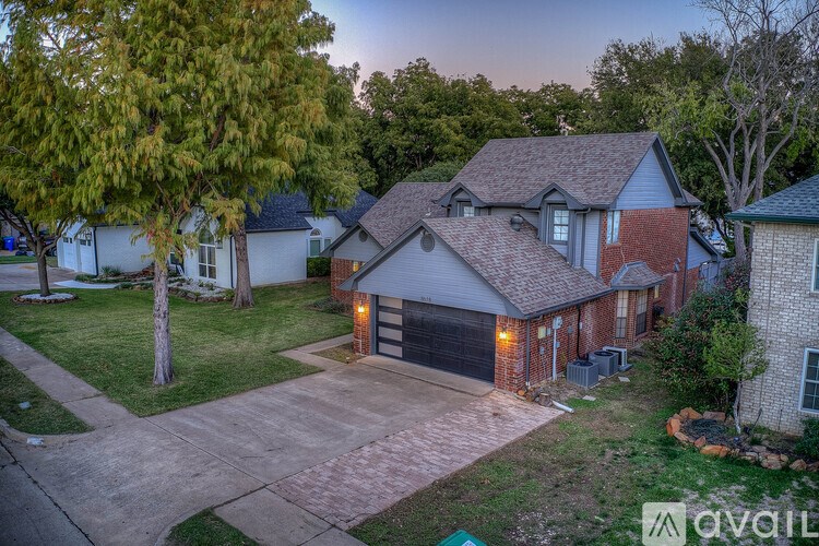 A house with a driveway and garage is available for sale.