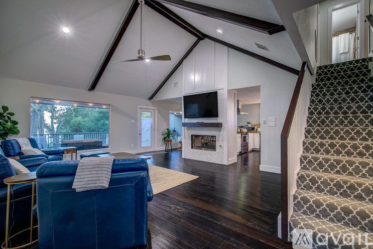 A living room with a blue sofa and a television.