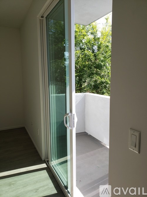 A glass door with a handle is open.