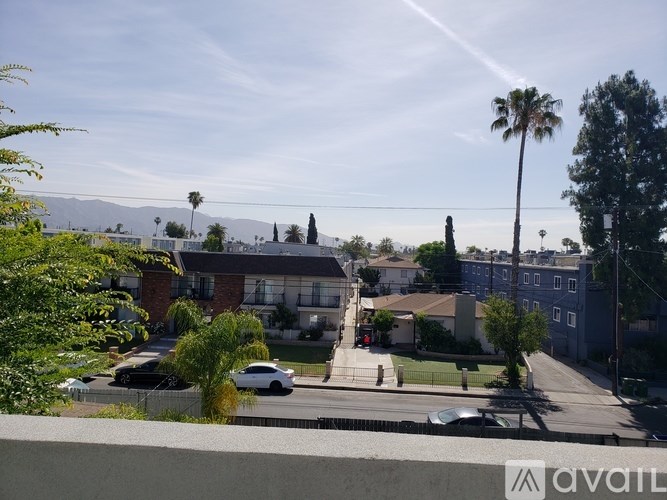 A street view with a car parked on the side of the road.