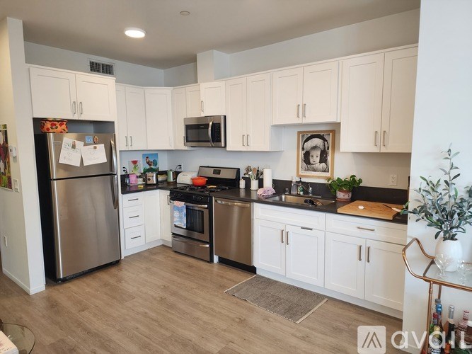 A kitchen with white cabinets and stainless steel appliances.