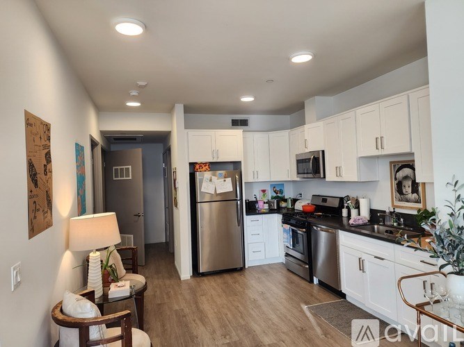 A kitchen with white cabinets and stainless steel appliances.
