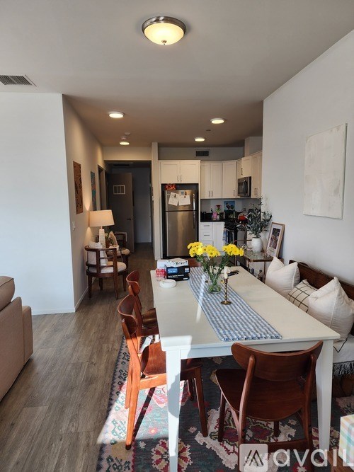 A dining room with a white table and chairs.