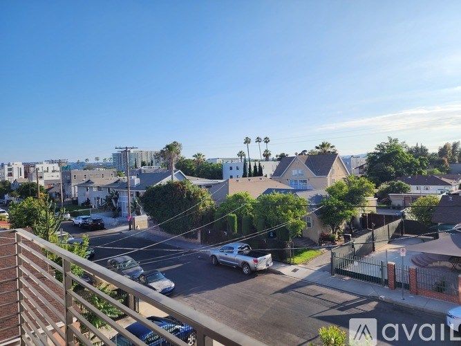 A street view with cars and houses.