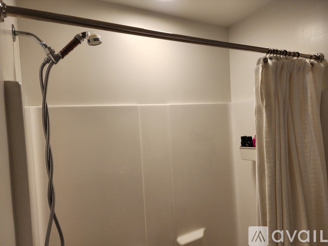 A shower head with a hose attached to it.