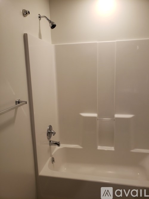 A white bathroom with a tub and shower.