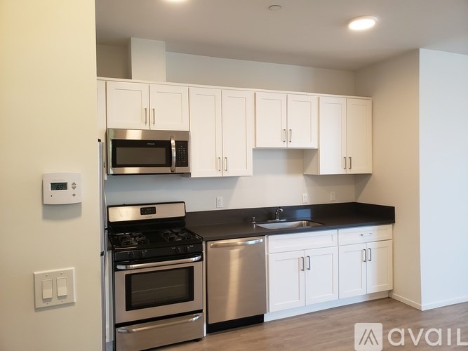 A kitchen with white cabinets and stainless steel appliances.