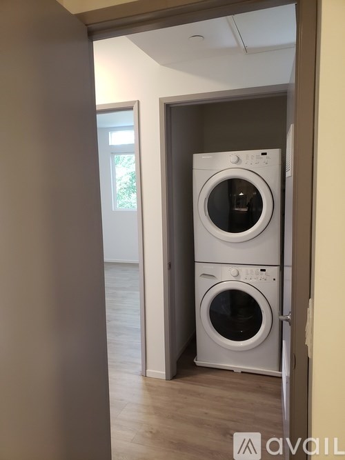 A stacked washer and dryer in a laundry room.