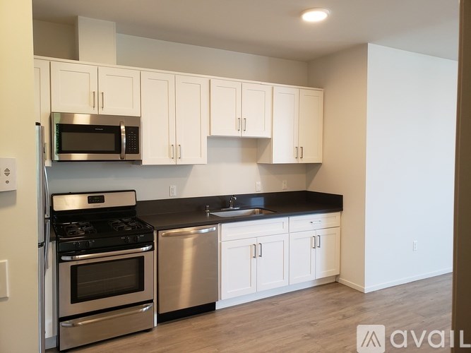 A kitchen with white cabinets and stainless steel appliances.