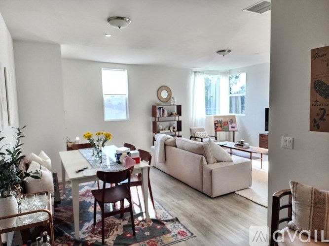 A living room with a dining table and chairs.