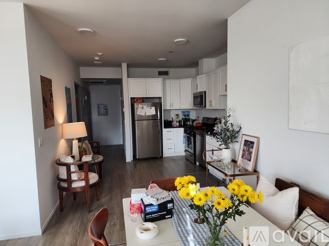 A kitchen with a table and chairs in the foreground.