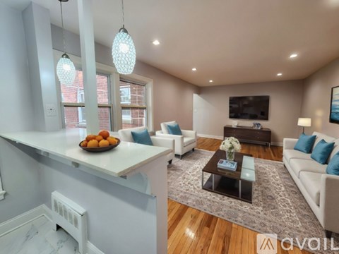 A living room with a white couch and a coffee table.