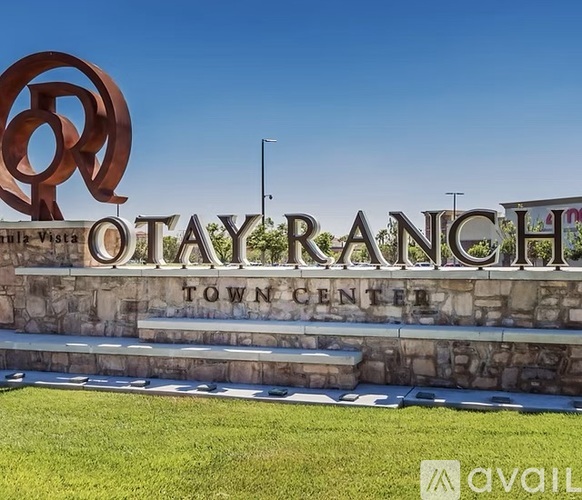 A large sign that says Otay Ranch Town Center in front of a grassy area.