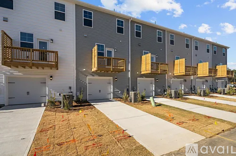 A row of new apartment buildings with balconies and garages.