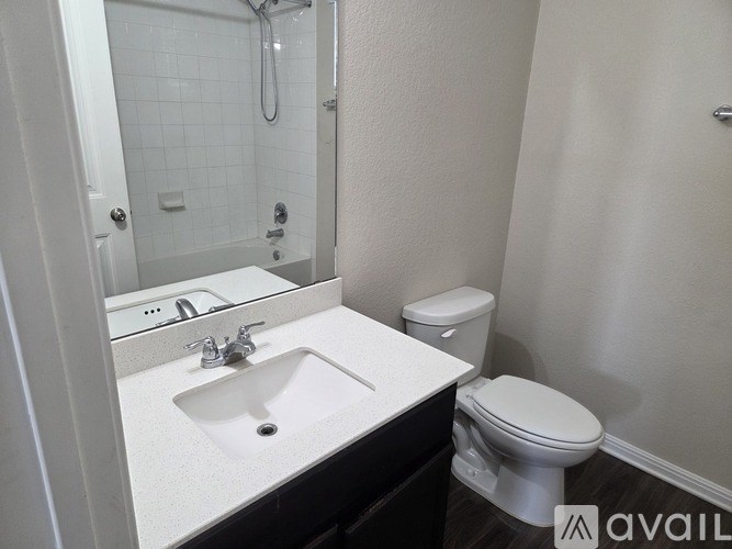 A bathroom with a white sink and toilet.