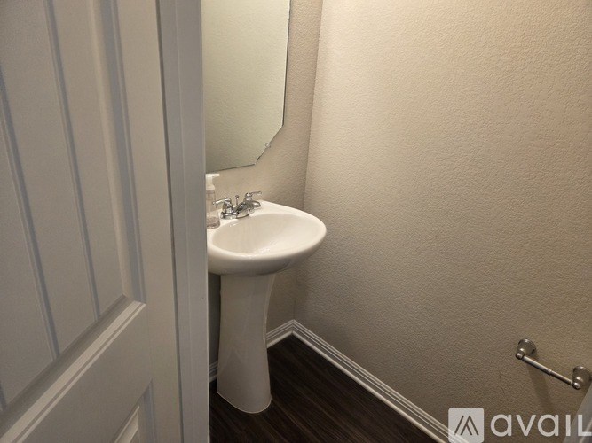 A white sink in a small bathroom.