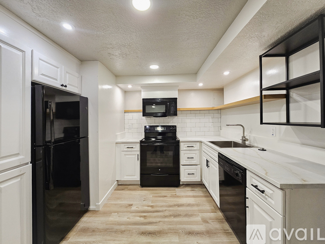 A kitchen with a table and chairs in front of a refrigerator.